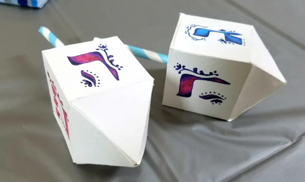 These free printable dreidel boxes are perfect for the Jewish holiday of Hanukkah or Chanukah as it's often called! It's perfect for filling with chocolate coins - or gelt- and make a great Hanukkah party favor or treat box. This Hannukah craft is great to use for small gifts too!